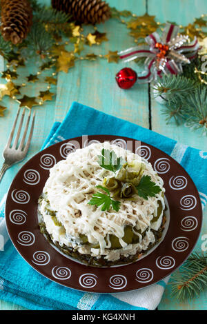 Home snack on the kitchen wooden table. Salad with chicken, rice and sea cabbage. Stock Photo