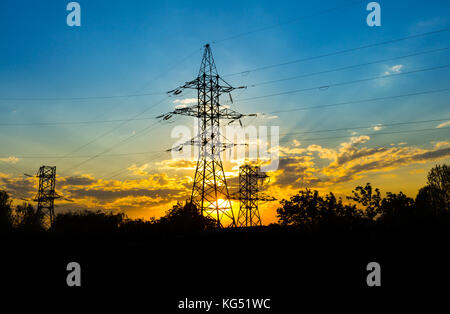 The silhouette of the evening electricity transmission pylon Stock Photo