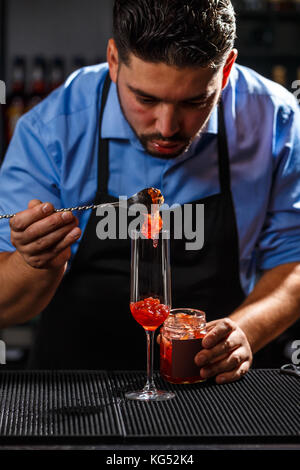 Bartender preparing cocktail with rose jam Stock Photo