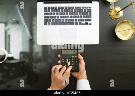 justice and law concept.businessman or lawyer or accountant working on accounts using a calculator and laptop computer and documents in modern office Stock Photo