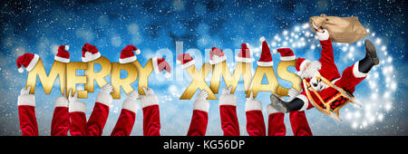 merry christmas xmas greeting crazy funny santa claus on sleigh and costume arms holding up golden letters on blue snow panorama background Stock Photo