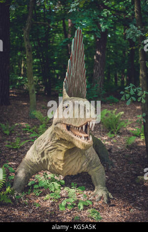 Solec Kujawski, Poland -  August 2017 :  Life sized spinosaurus dinosaur statue in a forest Stock Photo