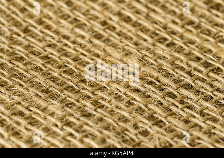 Jute fabric layers diagonal view. Coarse brown threads woven to rough textile, used for bags. Also called raw or golden fiber. Photo. Stock Photo