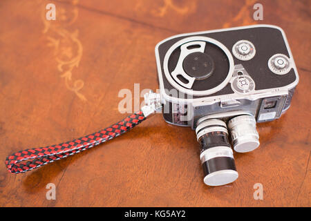 vintage video camera on a antique wooden table Stock Photo