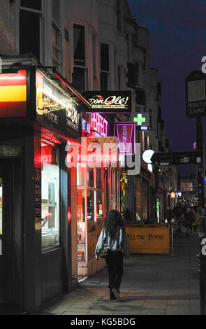 Variety of fast food outlets including Spanish tapas , Kebab shops and Fried Chicken in York Place Brighton at night Stock Photo