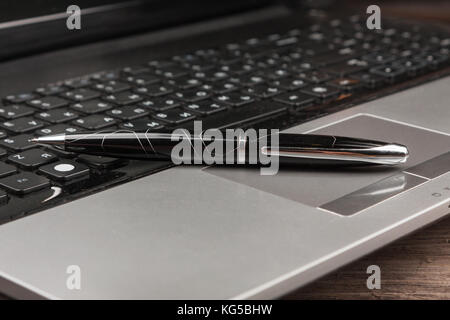 luxury black pen on the laptop. Business still life Stock Photo