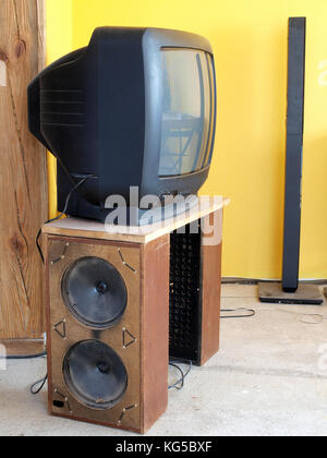 Old TV  set on homemade table from speakers in wood boxes Stock Photo