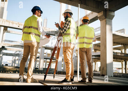 Team of construction engineers working on building site Stock Photo