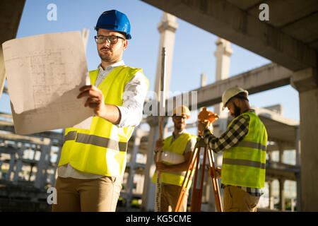 Portrait of construction engineers working on building site Stock Photo