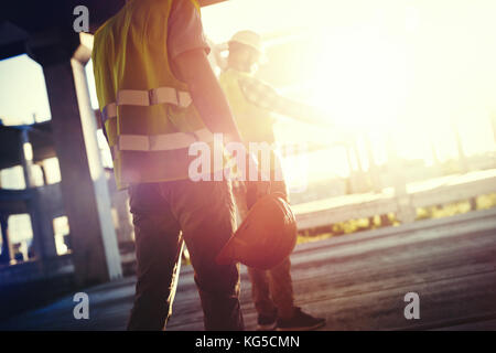 Portrait of construction engineers working on building site Stock Photo