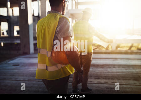 Portrait of construction engineers working on building site Stock Photo