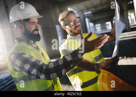 Portrait of construction engineers working on building site Stock Photo