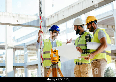 Portrait of construction engineers working on building site Stock Photo