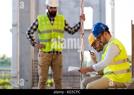 Portrait of construction engineers working on building site Stock Photo