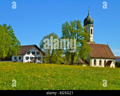 Germany, Bavaria, Froschhausen am Riegsee (lake), St. Leonhard church, Pension St. Leonhard (guesthouse), Meadow, trees, blue heaven, spring Stock Photo