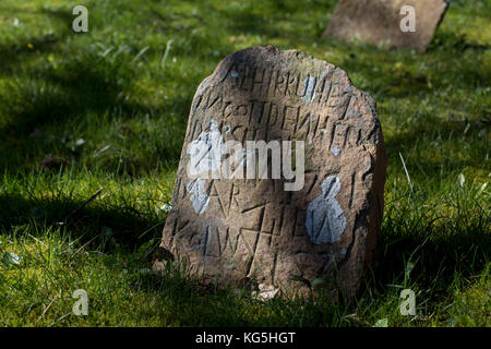 Runes on an ancient tombstone on the cemetery of Hiddensee island, Germany Stock Photo