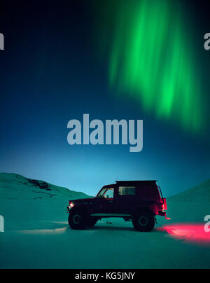 Truck in snow with Northern lights, Iceland Stock Photo