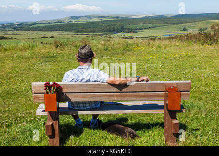 England, East Sussex, Eastbourne, South Downs National Park, Man Sitting on Park Bench Stock Photo