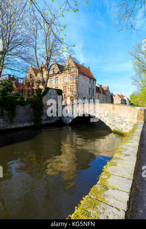 Historic buildings of the city centre framed by old bridge of the typical canal Bruges West Flanders Belgium Europe Stock Photo