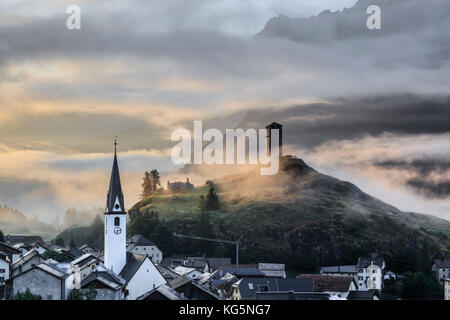 Misty sky on the alpine village of Ardez at sunrise, canton of Graubünden, district of Inn, lower Engadine, Switzerland, Europe Stock Photo