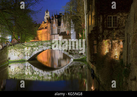 Night view of the medieval buildings of the city centre reflected in the typical canal Bruges West Flanders Belgium Europe Stock Photo