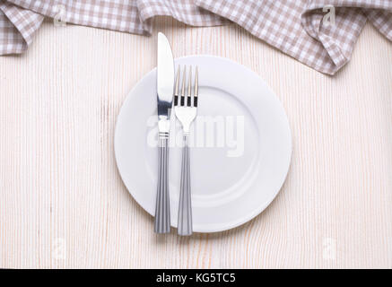Mock up plate on white wooden table with tablecloth Stock Photo