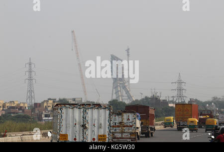 Commercial vehicles on outer ring road, Delhi. Under construction Signature Bridge on the river Yamuna at Wazirabad is also visible. Stock Photo