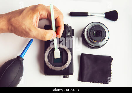 Mirrorless Sensor cleaning and Maintenance,Photographer hand cleaning sensor of camera by using sensor swab and vacuum pump,cleaning dirty camera sens Stock Photo