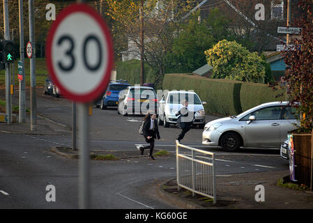 young children crossing the road without care running boy and girl school kids jay walking Stock Photo