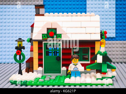 Tambov, Russian Federation - July 06, 2016 Lego girl with snowball near Christmas tree opposite her house. Studio shot. Stock Photo