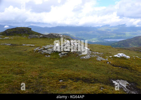 The Summit Pile of Stones on the Scottish Mountain Corbett Creag Mac Ranaich, Scottish Highlands. Stock Photo