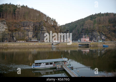Scenic view on Czech Hrensko village on Elbe river bank from ferry Schona near train station on German side in early winter evening. Stock Photo