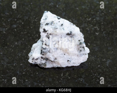 macro shooting of natural mineral rock specimen - rough Diorite stone on dark granite background Stock Photo