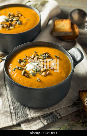 Homemade Curry Butternut Squash Soup with Sage and Bread Stock Photo