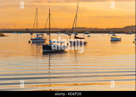 Suffolk UK river, view at sunset of sailing boats moored in the River Alde near Orford, Suffolk, UK Stock Photo