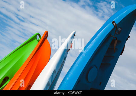 Sea Kayaks lined up on the beach Stock Photo