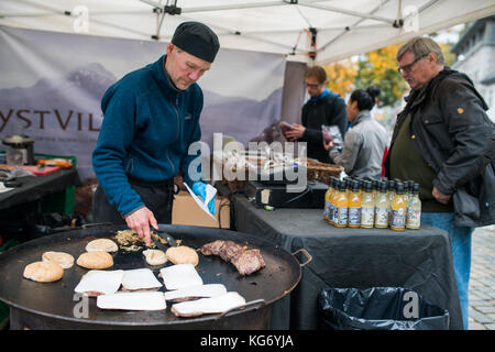 Bergen, Norway -  October 2017 :  Man preparing burgers on the street food market Stock Photo