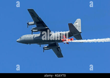 Michael Wiskus flies the Lucas Oil Pitts S-1-11B in formation with a Missouri Air National Guard C-130H2 from the 139th Air Wing based Rosecrans Air N Stock Photo