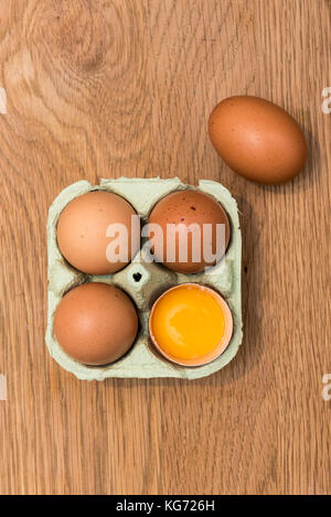 Close-up view of raw chicken eggs in egg box on  oak wooden background Stock Photo