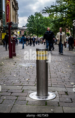 Automatic bollard preventing all but emergency vehicle access to St Ann's Square in Manchester Stock Photo