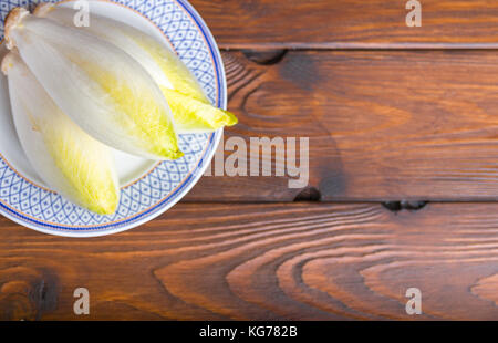 belgian witloof on a white plate Stock Photo