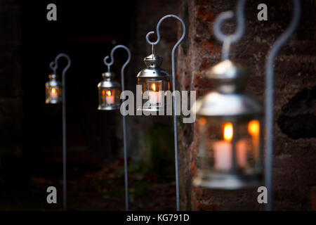A row of outdoor christmas candles with focus on the second one. Stock Photo