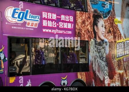 Hong Kong Bus with Travel Advertisement Stock Photo