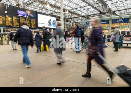 Commuters rush for their train during the rush hour at Edinburgh's Waverley Station. Stock Photo