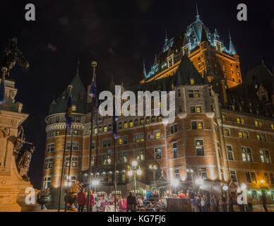 Street performers play before a crowd in front of the Fairmont Chateau Frontenac in Quebec City, Quebec. Stock Photo