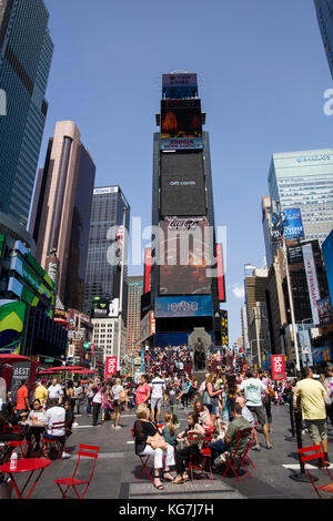 Unidentified people on the Times Square, New York. Times Square is the most popular tourist location in New York City Stock Photo