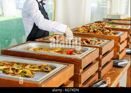 Outdoor Cuisine Culinary Buffet Dinner Catering. Group of people in all you can eat. Dining Food Celebration Party Concept. Service at business meetin Stock Photo