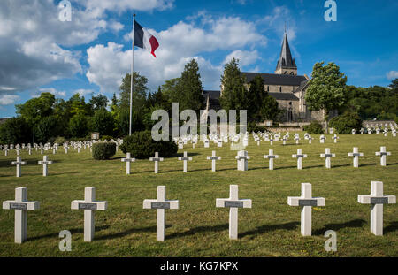 Chatillon-sur-Marne, France - June 7, 2017: War cemetery 1914-1918 of French soldiers in Chatillon-sur-Marne with French flag and church. Stock Photo