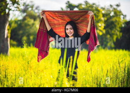 Beautiful young woman farmer in Thailand,Woman smiling with perfect smile and happy in forest. Stock Photo
