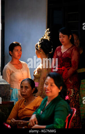 Ubud,Bali, Indonesia - October 31, 2010: In Bali, Young Indonesian bride is surrounded by her relatives before the wedding ceremony Stock Photo